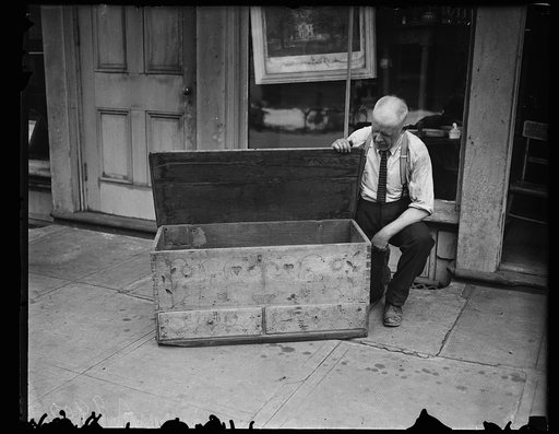 Man with antique wooden chest