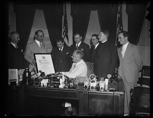 PRESIDENT RECEIVES FRATERNITY MEMBERSHIP SCROLL. WASHINGTON, D.C.,JUNE 24. PRESIDENT ROOSEVELT TODAY RECEIVED A SCROLL REPRESENTING HIS MEMBERSHIP IN THE GREEK ORDER OF AHEPA. HE WAS INITIATED INTO THE ORDER MARCH 11, 1931, WHEN GOVERNOR OF NEW YORK. THE GREEK EDUCATIONAL ASSOCIATION MADE THE PRESEN