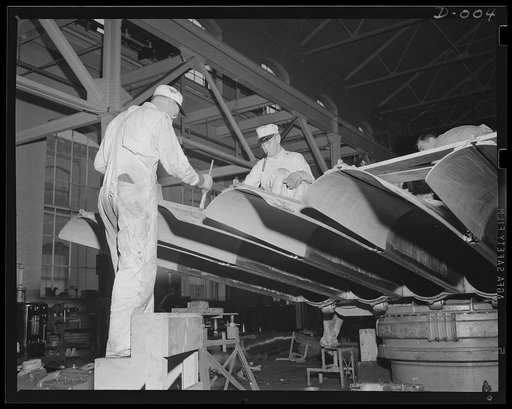 Torpedo tubes get coat of paint. Painters putting the finishing touches on torpedo tubes in production at an eastern Navy arsenal. All kinds of skilled workers are needed in the expanded war program. Production has been stepped up in this and ten other arsenals throughout the country