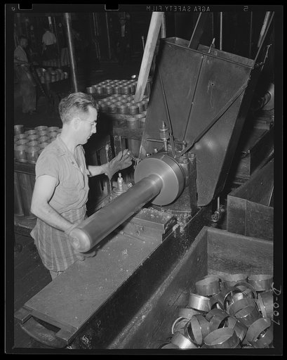Turning anti-aircraft catridges. One of the last processes in making anti-aircraft cartridges is turning the case. This skilled workman in an eastern Navy yard is one of thousands who are producing ammunition for the expanded Navy war program