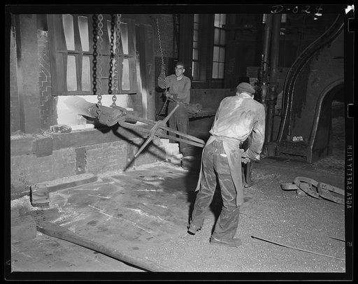 Furnaces in the Navy yard. Heating part of a big Navy gun preparatory to forging in one of eleven arsenals working at top speed for the expanded war program