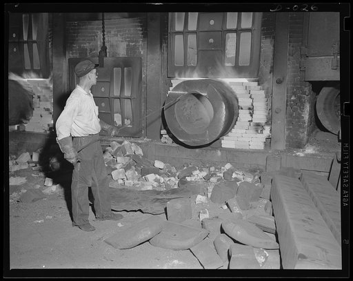 Big gun in the raw. Heating the cylinder for a large gun preparatory to forging it. Production of these guns for the war program is going ahead at top speed in eleven Navy arsenals throughout the country