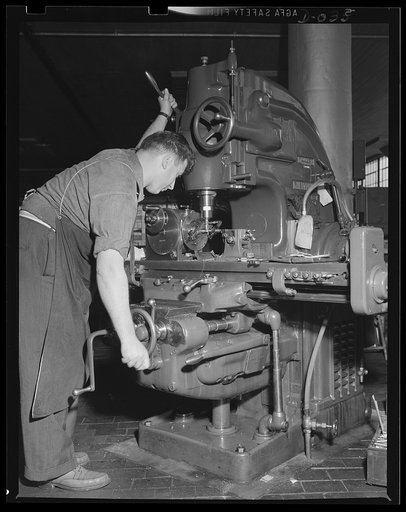 Squaring part of a torpedo. Skilled machine operator working on the process of torpedo manufacture in an eastern Navy arsenal
