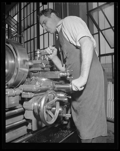 Skilled machine operator. A finishing cut on a turbine wheel in an eastern Navy arsenal where production has been stepped up to top speed to meet war needs