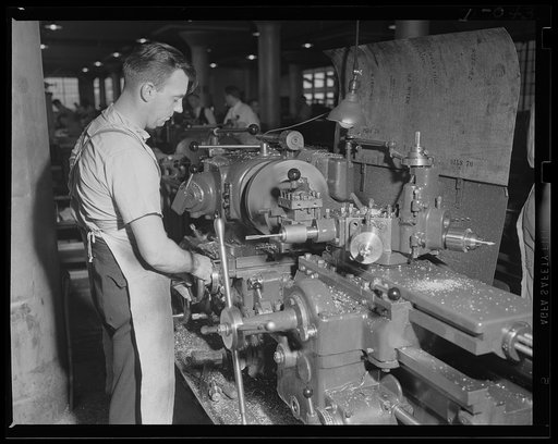 Machine for making torpedoes. Complicated operation of a turret lathe is this man's specialty. Location: a large eastern Navy arsenal