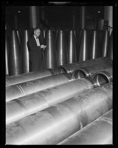 Ready for 1000 pounds of TNT. Checking up on torpedo parts which are being turned out at top speed for the two-ocean Navy at an eastern Navy arsenal