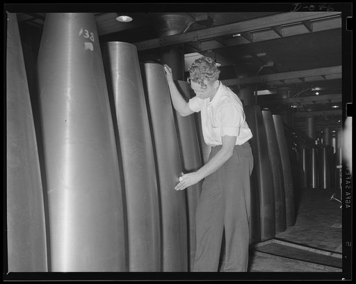 Torpedo rear ends. Checking the finish on the "after body" shells which carry the engine and aiming apparatus of torpedo. Location: a large eastern Navy arsenal