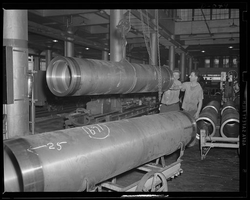 Juggling torpedoes. Shifting torpedo air flasks in process of manufacture at an eastern Navy arsenal, a vital part of the expanded Navy's equipment