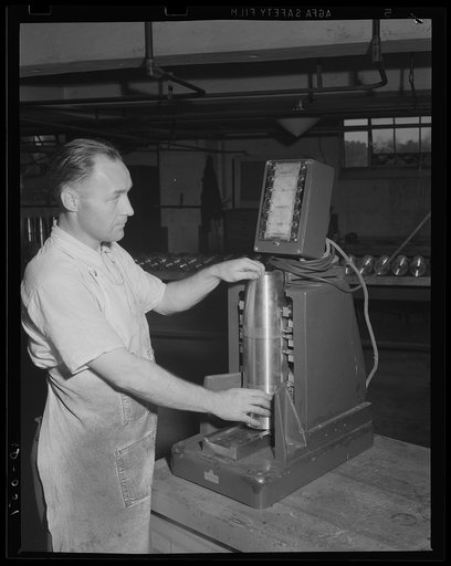 Superhuman electrical accuracy. Gauging the accuracy of a 155 mm shell by an electrolimit gauge which measures all parts and each curve to the ten-thousandth of an inch. Location: a large eastern arsenal