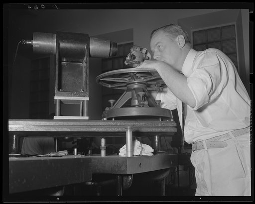 Getting ready to aim at what you hit. Careful adjustment of the aiming circle for sighting the target. These precision instruments, as well as ammunition, are made at a large arsenal