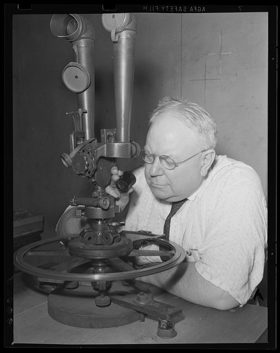 Neck chamers for the artillery. A battery commander telescope expert checking its azimuth circle. Fine instruments are as necessary a part of production at the Army, in which this equipment is produced, as big guns