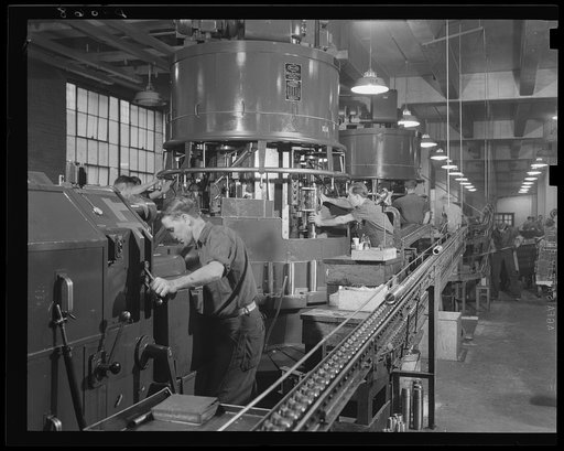 Battery of machines to arm batteries of guns. Both ends of the 75 mm shells are worked at once on these multiple spindle machines in a large eastern arsenal