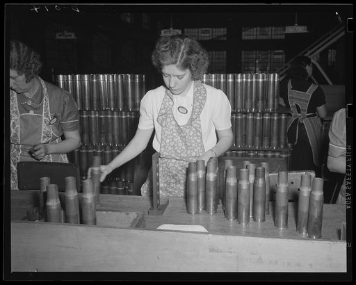 Critical eye on cartridge cases. Final inspection of 75 mm cases coming down the line in a steady stream at a large eastern arsenal for the Army's artillery