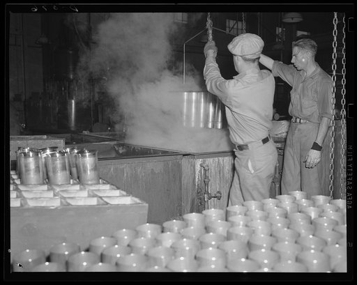Sizzling brass. Annealing the mouths of thousands of cartridge cases. These are for the Army's light artillery 75s. Site: a large eastern arsenal