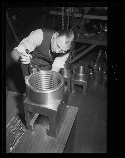 No margin for error here. Micrometer readings are taken to make sure that every part fits perfectly in the guns being manufactured for war purposes. This worker is inspecting a breech ring for medium-caliber guns in a large eastern arsenal
