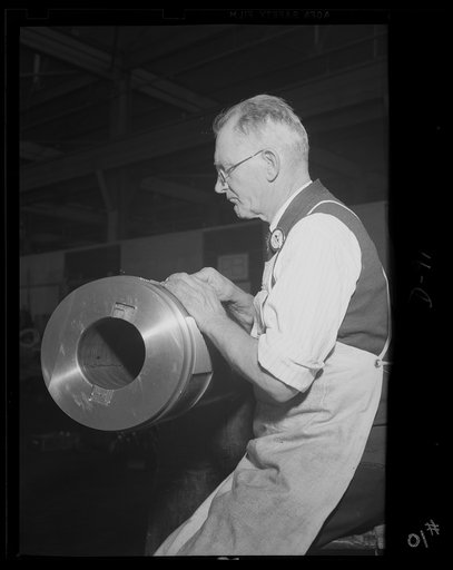 Putting the parts together. Fitting the breech ring seat on one of the medium caliber guns rolling from a large eastern arsenal working full speed for victory
