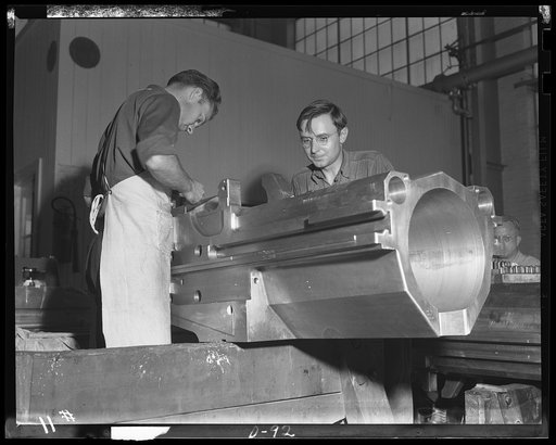 Business district. Bench workers finishing a breech housing for a medium caliber gun in a large eastern arsenal. This is a section of the business part of one of the guns being turned out for the war production program