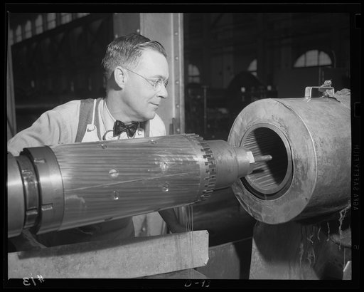 Making accuracy certain. Rifling grooves to speed shells on their way with accuracy are cut in a medium-caliber gun in a large eastern arsenal