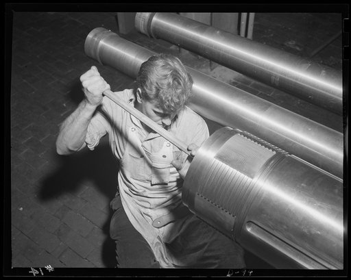 The man behind the gun. Worker in an eastern arsenal finishing up the breech end of a tube of a medium-caliber gun for the war program