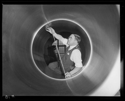 A smoothy enlists. Polished interior surface of a big gun for Uncle Sam's war program. The bore diameter of hoop is measured in the large eastern arsenal where the work is carried on