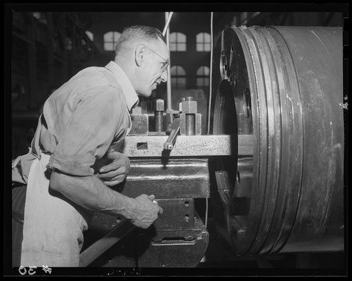 Accuracy comes first. Experienced inspectors check clip hoops for the ultimate in accuracy. The operation is part of the rush of defense orders in an eastern arsenal