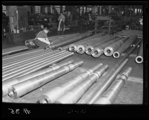 Answering the call. Dozens of partially-machined tubes for medium caliber guns await finishing processes in an eastern arsenal. Every day finds Uncle Sam's defensive armament stronger