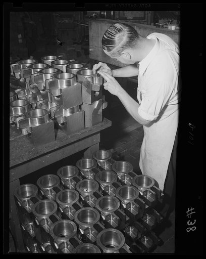 Another batch coming up. Parts for dozens of small guns are checked for accuracy in an eastern arsenal. These are breach rings that will soon be fitted into cannons for the war program