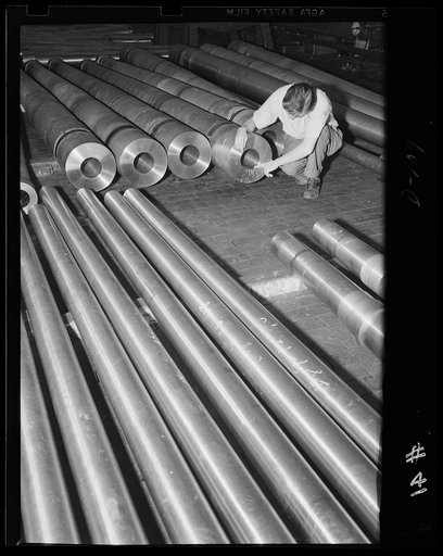 Rolling em' out. Tubes and liners for medium caliber guns are prepared for finishing operations in an eastern arsenal. The cannons are being rushed for the war program. "All out for defense"