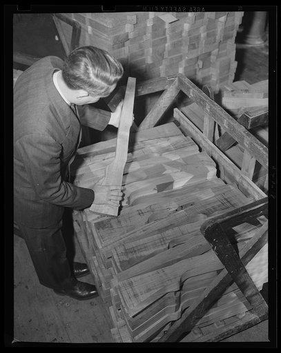 In the rough. The first rough cut has been made in these rifle stocks as they take shape from the blank. Part of the war work at an eastern armory