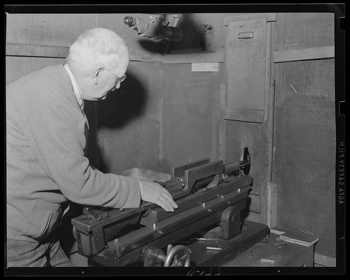 Testing for accuracy. Checking the straight-shooting qualities of one of the semi-automatic rifle which play an important role in our war preparation. Note the ejected cartridge flying through the air in the upper right hand corner of the photograph