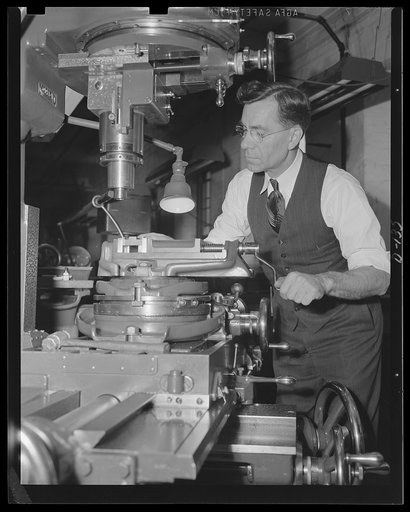 Invention for defense. John C. Garand, inventor of the Army's semi-automatic rifle, at work in his model shop