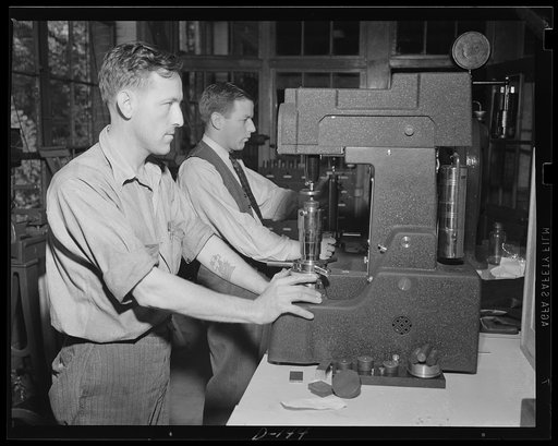 Tough steel for a tough job. It takes tough steel to stand up in a Garand rifle. Here workmen are testing the hardness of steel at an eastern armory, a center of war work