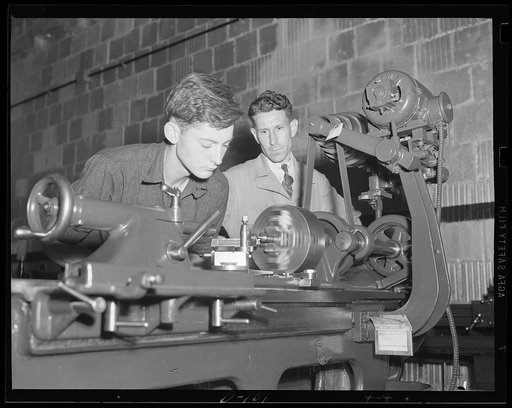 Study in concentration. Apprentice at an eastern arsenal, operates an engine lathe under the watchful eye of an instructor. Many such study operators are being trained for the war program