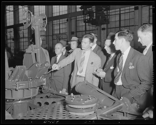 Inspectors instructed. Student inspectors learn the ins and outs of their trade at an eastern arsenal. The mechanism under discussion is that of a 37 mm gun anti-aircraft carriage, M-3, one of the army being turned out for war work