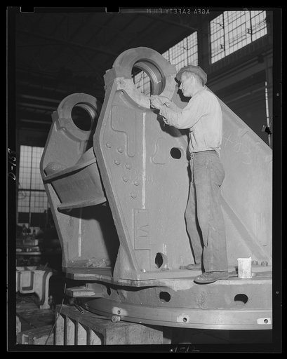 Mobile defender. A big piece for a railway gun is polished up. Worker at an eastern arsenal, engages in a finishing operation on the trunnion bearing ring for an 8-inch gun railway carriage