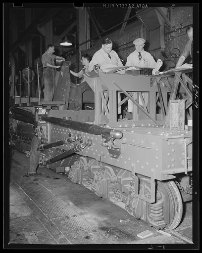 Movable might. The erection of an 8-inch gun railway carriage nears completion in an eastern arsenal. Fitted with its big cannon, the carriage will be a potent force for war work