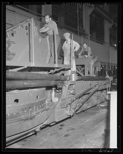 Putting the parts together. Assembly of an 8-inch railway gun carriage in an eastern arsenal. The big gun is one of many speeded for war work