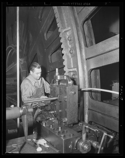 Geared to defense. A 16-inch gun carriage elevating rack has its gears cut by a workman in an eastern arsenal