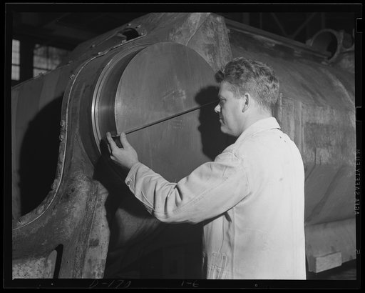No second guesses. Every part of every gun turned out for national defense is inspected for accuracy. Inspector at an eastern arsenal checks the dimensions of a finished trunnion for a 16-inch gun, barbette carriage