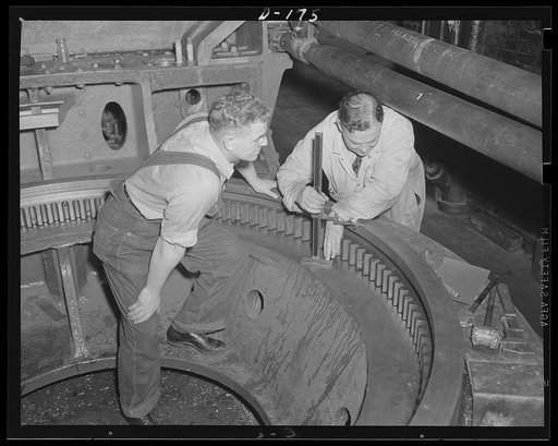 Firm understanding. The big base ring for an 8-inch gun, railway carriage, is inspected in an eastern arsenal