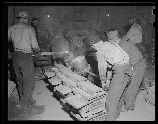Metal for munitions. Hot brass pours into moulds at an eastern Navy yard, rush foundary operations for greater U.S. fleet