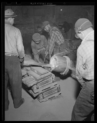 Work for steady hands. Carelessness does not mix with molten brass as the concentration of workers shows in this closeup of foundary operation at an eastern Navy yard