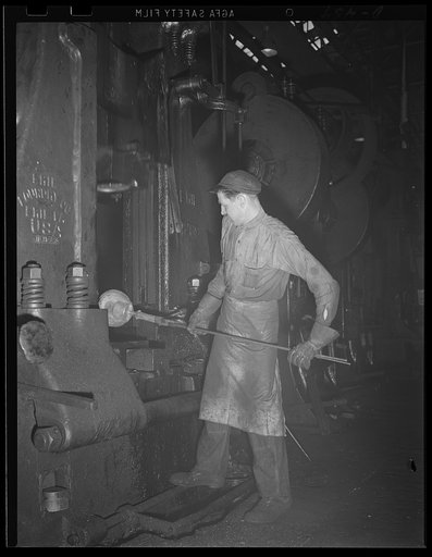 A blow for democracy. A heavy steam hammer at Navy yard is used in the forging of hot metal into a turnbuckle for one of the Uncle Sam's new ships