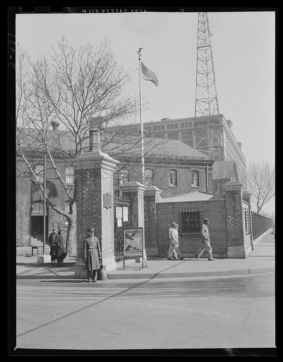Outpost of democracy's arsenal. Gate of an eastern Navy yard, a well-guarded portal behind which units of Uncle Sam's two-ocean Navy are being rushed to completion