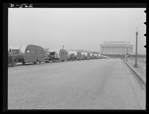 Emergency caravan. To provide temporary housing for defense workers while more permanent quarters are being built for them, this caravan of trailers crosses Memorial Bridge, Washington, D.C., on its way to Wilmington, North Carolina. Trailers are being used all over the U.S. to provide this type of 