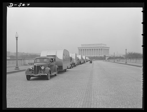 Emergency caravan. To provide temporary housing for defense workers while more permanent quarters are being built for them, this caravan of trailers crosses Memorial Bridge, Washington, D.C., on its way to Wilmington North Carolina. Trailers are being used all over the United States to provide this 