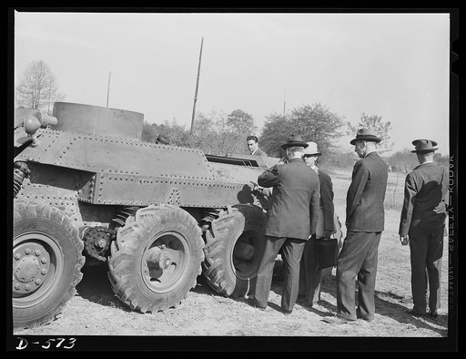 Secretary of War Henrey L. Stimson (back to camera) inspecting new trackless tank during demonstration at Fort Myer, Virginia. For further data see caption for pix D-570