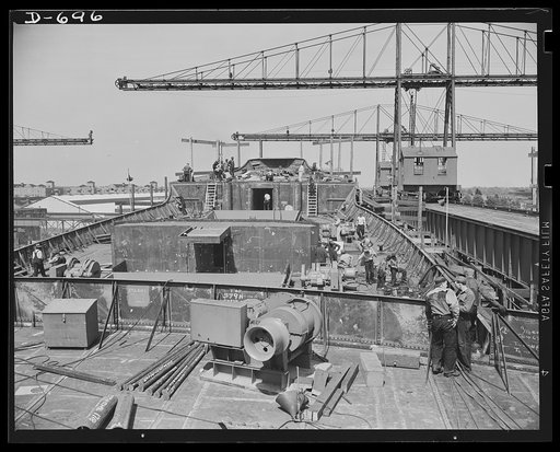 Newport News, Virginia. The forward deck on a C-3, photographed from the bridge. Winch in foreground; winch platform in center of picture. The mast has not yet been installed on the ship. (C-3 refers simply  to the type of ship design.)