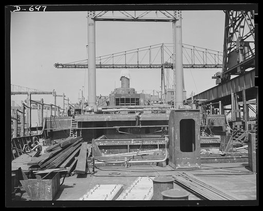 Newport News, Virginia. The afterdeck, looking forward to deck housing, on a C-3 under construction. The two erect beams visible are Samson posts
