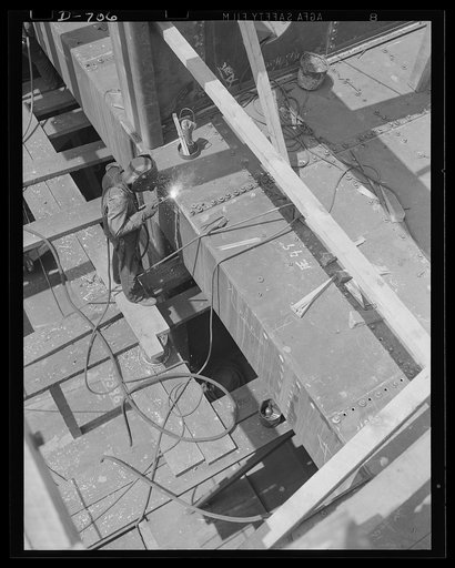 Newport News, Virginia. Welder electro-welding the seam of a hatch combing on a C-3